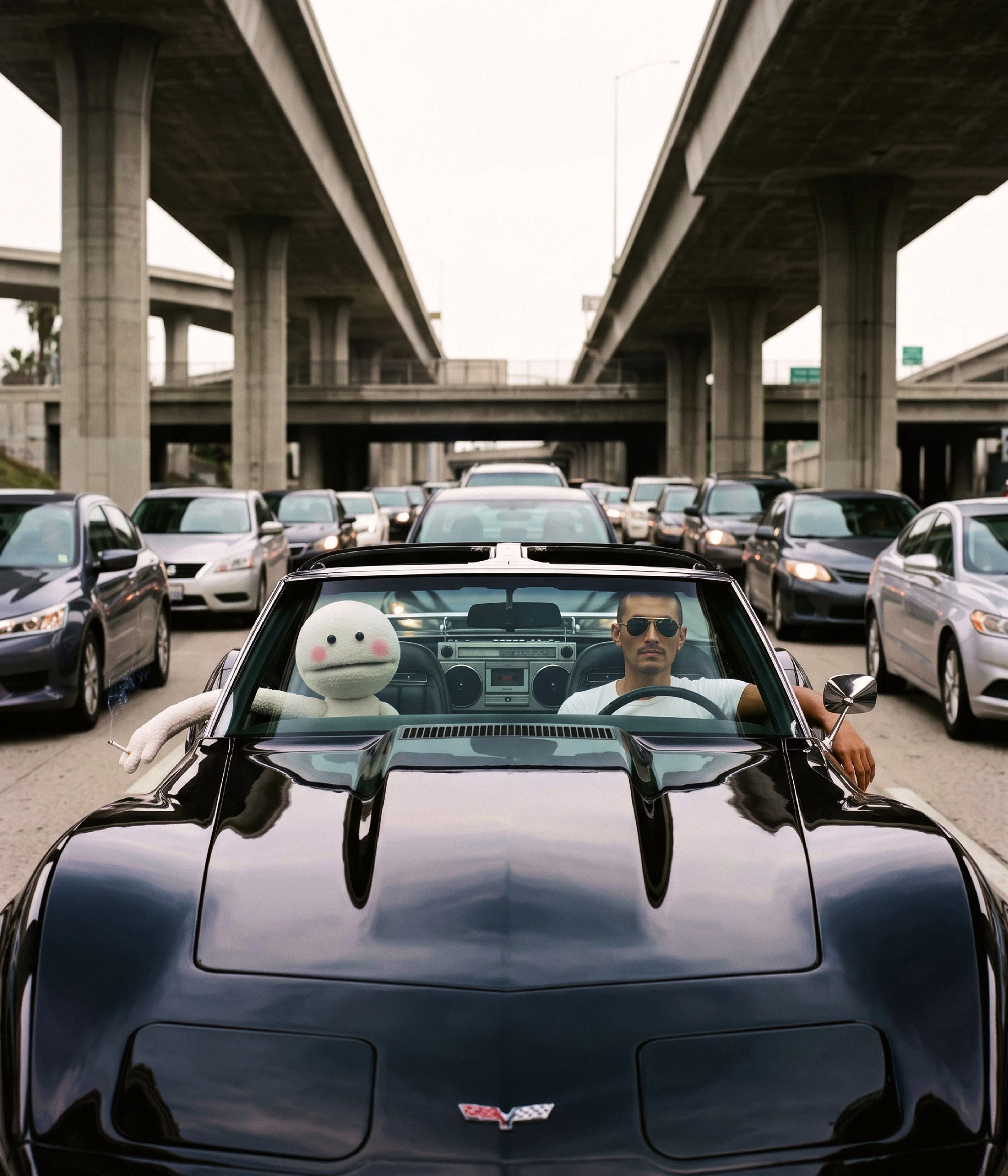 CVS and George in a black Corvette on the LA freeway